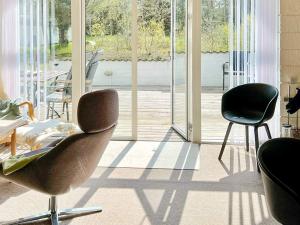 灵克宾Holiday Home Strandgårdsvej III的客厅配有两把椅子和大窗户