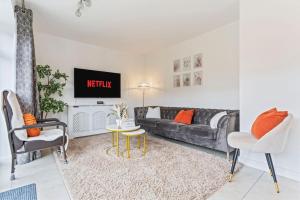 伯明翰Luxury Modern House - 8 mins to NEC, Airport的带沙发和电视的客厅