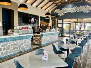 巴利托Ballito Splash的一间带桌椅的餐厅和一间酒吧