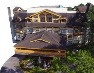 碧瑶A paradise nestled in the City of Pines, Camp John Hay Baguio City的享有带花园的大型建筑的顶部景色