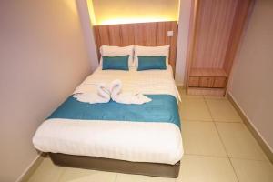 吉隆坡吉隆坡中心欧罗生活酒店的一间卧室配有一张床,上面有两条毛巾