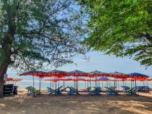 七岩班恩班底度假酒店的海滩上的一组椅子和遮阳伞