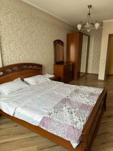 比什凯克guest house djal的一间卧室配有一张大床、梳妆台和镜子