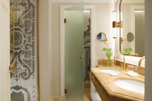 马德里The Westin Palace, Madrid的一间带两个盥洗盆和淋浴的浴室