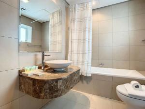 迪拜Key View - Hilliana Tower的浴室配有盥洗盆和浴缸。