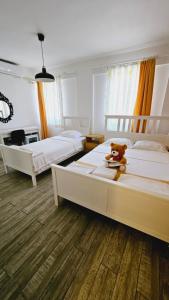 博兹贾阿达岛Ada Kalimera Bozcaada的一间卧室配有两张床,楼上设有泰迪熊