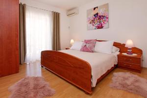 尼亚卢卡Sunshine Apartment Doda的一间卧室配有一张大木床和2个地毯