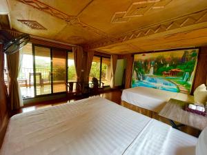 宁平Tam Coc Eco Field Homes的酒店客房设有两张床和大窗户。