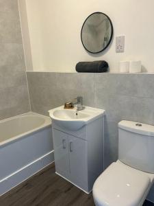 Free Parking! Comfy home in Barwell, Leicester -b-的一间带水槽、卫生间和镜子的浴室