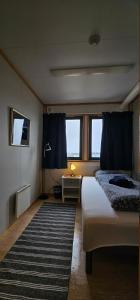 GamvikGamvik brakkebo as的一间卧室配有一张床和一张带台灯的桌子