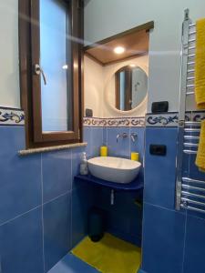 阿杰罗拉Nilu's Central House的蓝色的浴室设有水槽和镜子
