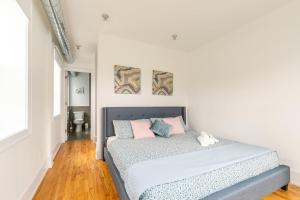多伦多Modern 2 BR Condo - Heart of Leslieville的一间卧室配有带粉红色和蓝色枕头的床
