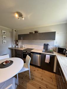雷克雅未克Reykjavik Urban Escape 2-Bedroom Haven with Private Entrance的厨房配有白色桌子、白色桌子和桌子