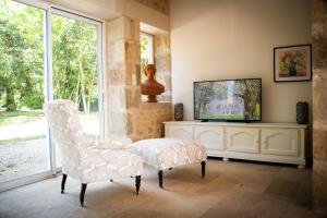 SanxayDomaine de la Briouse的客厅配有电视和椅子