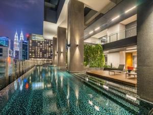 吉隆坡Kuala Lumpur Anggun Suite KLCC的一座城市天际线建筑中的游泳池