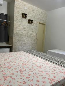 马塞约Pousada Beija Flor的一间卧室设有一张床和砖墙