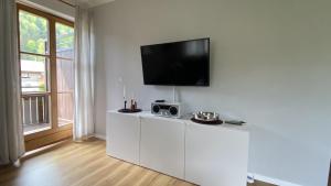 希格斯多夫Ferienwohnung Hammer - Alpenblick的一间客厅,在白色的墙上配有电视