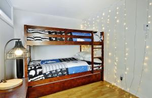 斯托纳姆51 Chemin de la Corniche的卧室配有两张双层床,墙上挂着灯