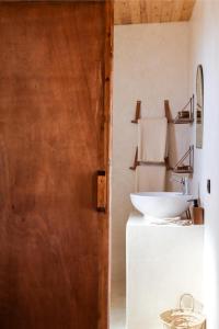 依索安The O Experience - Tayourt Lodge的一间带水槽、镜子和门的浴室