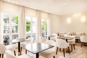 毕达哥利翁Doryssa Method Hotel的餐厅设有桌椅和窗户。