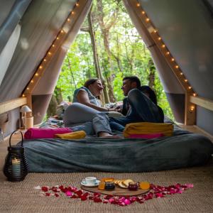 热那亚Glamping Montecontessa by SMART-HOME, Tipì的一群人坐在帐篷里的床上