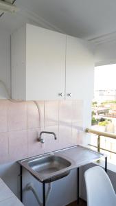 都拉斯Villa Osmani的厨房配有水槽和白色橱柜