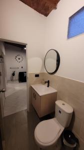麦德林La Familia Hostel - Manila的浴室设有卫生间、镜子和水槽