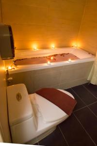 新山大世界酒店的浴室设有卫生间和浴缸及照明设施。