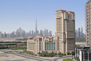 迪拜Marriott Hotel Al Jaddaf, Dubai的一组高大的建筑,以城市为背景