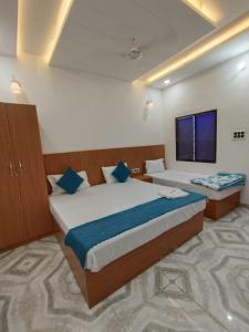 AyodhyaHotel Nirmala palace ayodhya Near Shri Ram Janmabhoomi 600m的酒店客房设有两张床和电视。