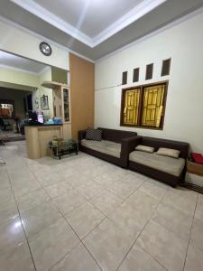 Green House Rawageni的带沙发和瓷砖地板的客厅