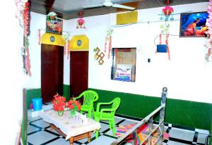 马图拉Radhey Krishna home stay的配有桌子和两把椅子以及一张桌子和椅子的房间