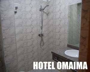 阿尤恩Hotel OMAIMA的带淋浴、卫生间和盥洗盆的浴室