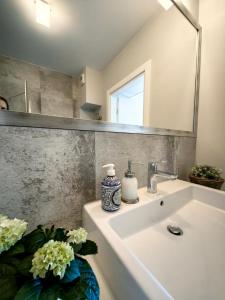 米兹多洛杰Edel Exclusive Apartments Horyzont 414 Especially for You的浴室水槽,配有镜子和花瓶