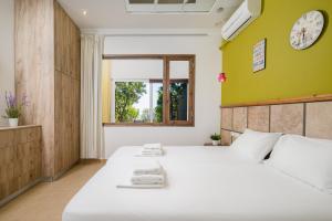 赫索尼索斯More Crete Village House Koutouloufari - Outdoor Pool - 6 guests的卧室设有一张白色大床和一扇窗户。