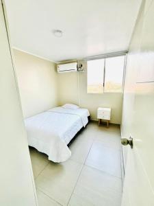 利马Cozy Peruvian Home的小房间设有床和窗户