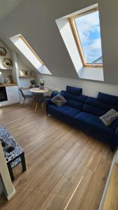 卢布林Apartamenty Nowickiego的客厅配有蓝色的沙发和桌子