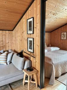 Hytte nær Ål的卧室配有木墙内的一张床