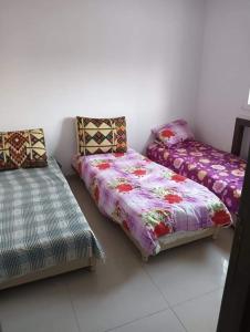 El AhmarRésidence Sousse的客房设有两张单人床和一张沙发。