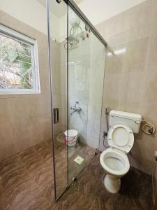 浦那Elite Stays Viman nagar的一间带卫生间和玻璃淋浴间的浴室
