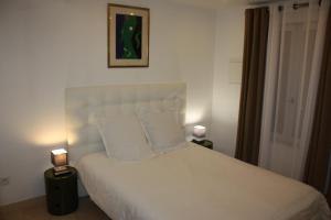 特鲁瓦克洛斯圣尼兹尔度假屋的一间卧室配有一张带两盏灯的大型白色床。