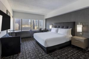 旧金山希尔顿旧金山金融区酒店的卧室设有一张白色大床和大窗户