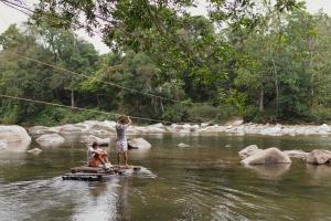 伯里塔卡La Ponderosa Reserve的两个人站在河里的木筏上
