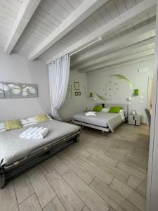 波佐伦戈B&B La Terrazza的一间卧室设有两张床,铺有木地板