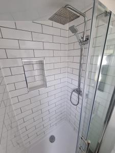 惠茨特布尔Alberta holiday park的白色瓷砖淋浴间和玻璃淋浴间