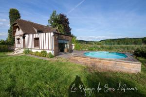 Arnières-sur-ItonLe Refuge du Bois d'Amour的庭院中带游泳池的房子