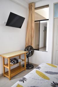 帕拉卡斯Hospedaje El Buen Samaritano的一间卧室配有书桌和镜子