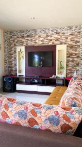 巴克里索莫雷诺港Casa en san Cristobal的客厅配有平面电视和1张床。