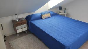 塞沙尔Seixal Yachting Bay Apartments的一间卧室配有蓝色的床和床头柜