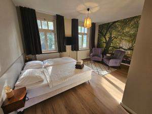 阿尔森德阿森瑟赫伯格酒店的一间卧室配有一张床和两把椅子